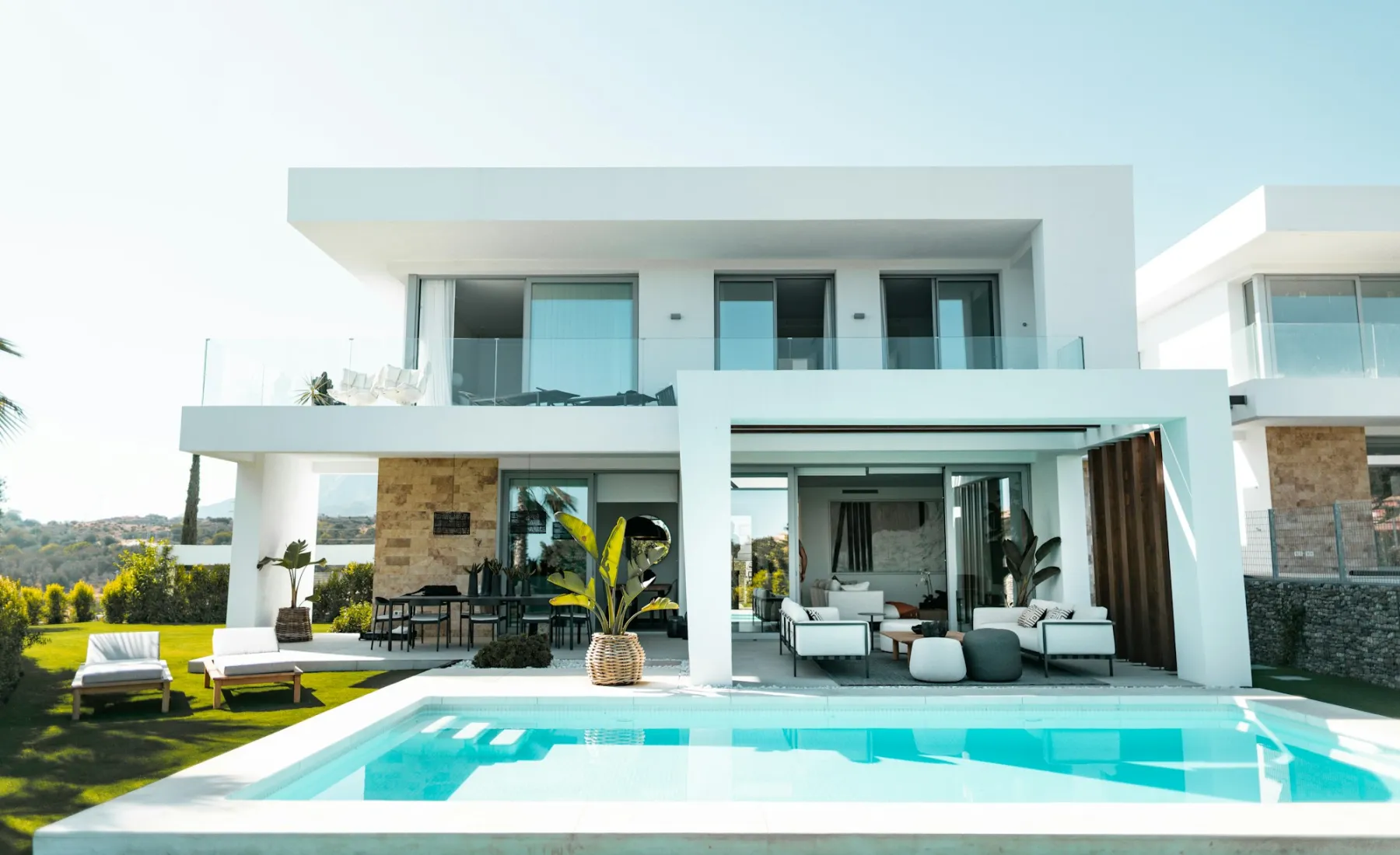 A modern white villa with a pool